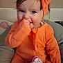 Helyana participe au concours pour gagner de l'argent avec cette photo : baby, infant, toddler, smiling, orange_clothes, headband, bow, pacifier, stuffed_toy, blanket, indoors, portrait, cute, hand_in_mouth, rosy_cheeks, sitting, big_eyes, brown_hair, bed, cozy