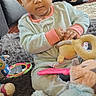 Ny'Ari is registered to the contest to win money with this photo: baby, child, infant, portrait, sitting, indoors, smiling, wide_eyed, face, hands, onesie, clothing, stuffed_animal, plush_toy, rattle, baby_toys, rug, couch, nike_bag, home_interior
