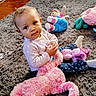 baby, child, infant, portrait, sitting, indoors, rug, plush_toy, stuffed_animal, doll, pink, blue, polka_dot, clothing, smiling, curious, playroom, toy, floor, cozy