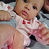 Ny'Ari is registered to the contest to win money with this photo: baby, infant, child, face, portrait, closeup, looking_at_camera, curious, eyes, mouth, hands, strawberry_pattern, pink_clothing, onesie, blanket, cuddling, indoor, selfie, soft_lighting, person