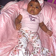Sernity is registered to the contest to win money with this photo: baby, child, infant, pink, blanket, headband, floral, clothing, cute, portrait, sitting, pattern, fabric, soft, indoors, person, young, adorable, face, expression