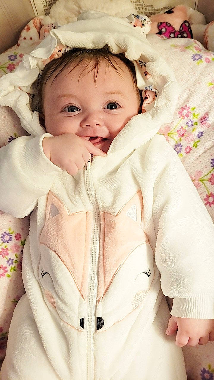 Kyrah is registered to the contest to win money with this photo: baby, baby_toddler_clothing, cheek, child, collar, comfort, face, fur, gesture, happy, iris, jacket, linens, lip, person, pink, skin, sleeve, smile, toddler