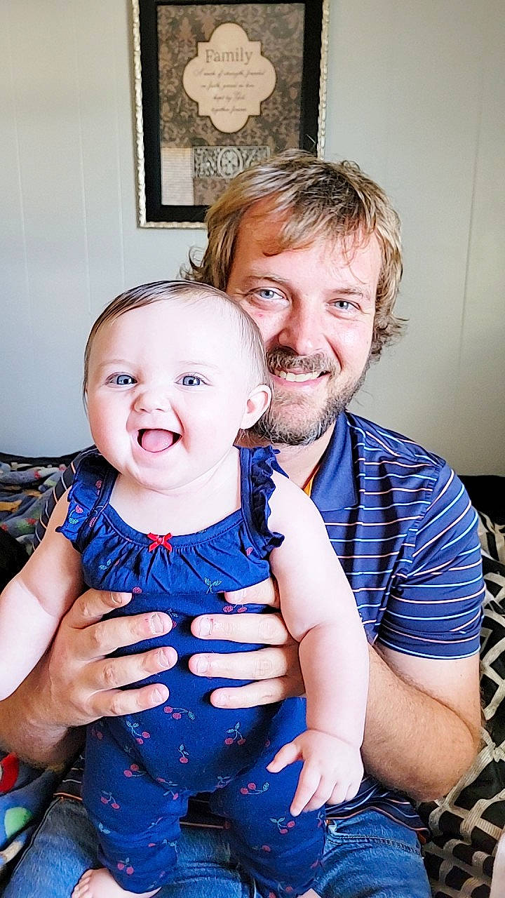 Kyrah is registered to the contest to win money with this photo: arm, baby, baby_toddler_clothing, event, eye, face, flash_photography, fun, gesture, hand, happy, head, interaction, iris, joy, person, picture_frame, shoulder, smile, standing