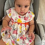 Emili participe au concours pour gagner de l'argent avec cette photo : baby, child, girl, infant, headband, dress, patterned_clothing, sitting, baby_chair, curious, cute, indoor, soft_lighting, hand, footwear, white_socks, colorful, animal_print, flower_print, comfort