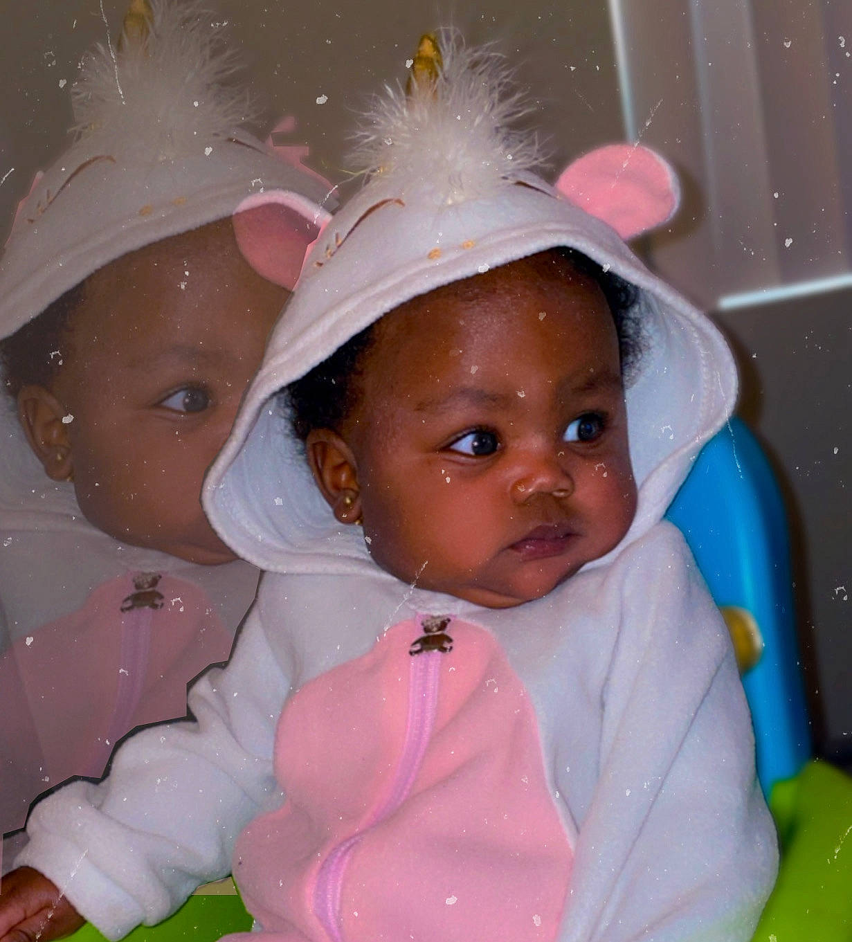 Amari is registered to the contest to win money with this photo: baby, bonnet, cap, clothing, coat, face, fashion, hat, head, hood, hoodie, indoors, jacket, knitwear, person, photography, portrait, sweater, sweatshirt, toy