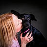 woman, dog, black_dog, pet, love, affection, portrait, studio, pink_collar, human, animal, face, closeup, head, hands, bond, expression, cute, friendship, dark_background