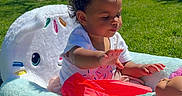 Xamira joined the competition — help win amazing prizes! toddler, child, doll, plush_chair, pink_bow, outdoor, grass, trees, sunny, blue_sky, toy, baby, cute, playing, pink, colorful, park, young_child, sitting, daytime