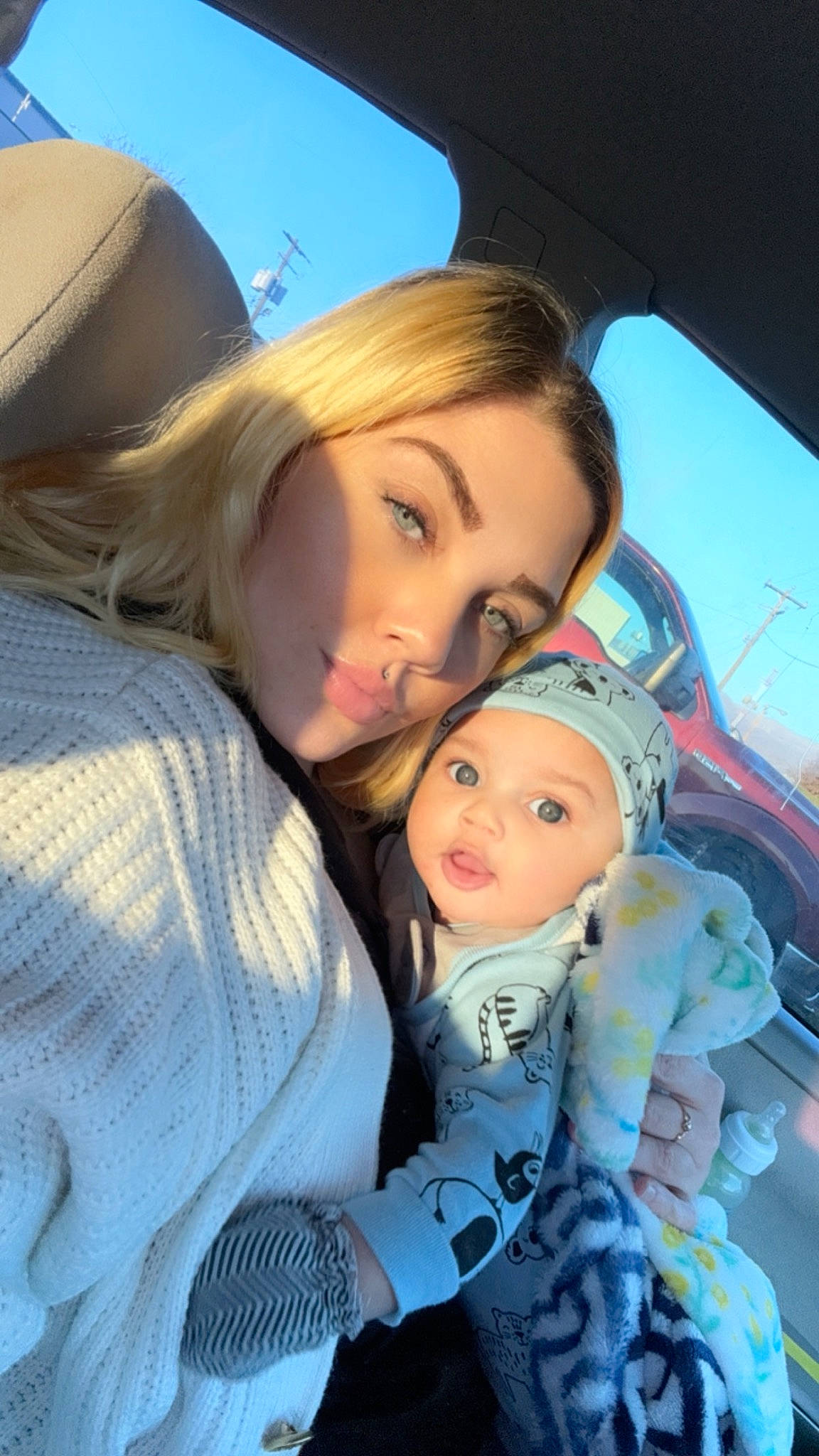 Malakhi is registered to the contest to win money with this photo: auto_part, baby, cap, car_seat, child, cool, family_car, fun, happy, hat, headwear, interaction, leisure, luxury_vehicle, motor_vehicle, nose, person, skin, toddler, travel