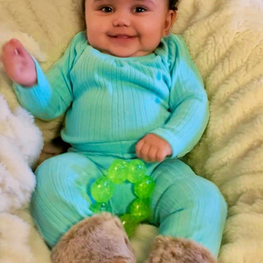 Cayla joined the competition — help win amazing prizes! baby, blanket, child, comfortable, cozy, curly_hair, cute, fuzzy_boots, green_toy, happy, home, indoors, infant, portrait, sitting, smile, soft_texture, teething_toy, turquoise_clothing, warm