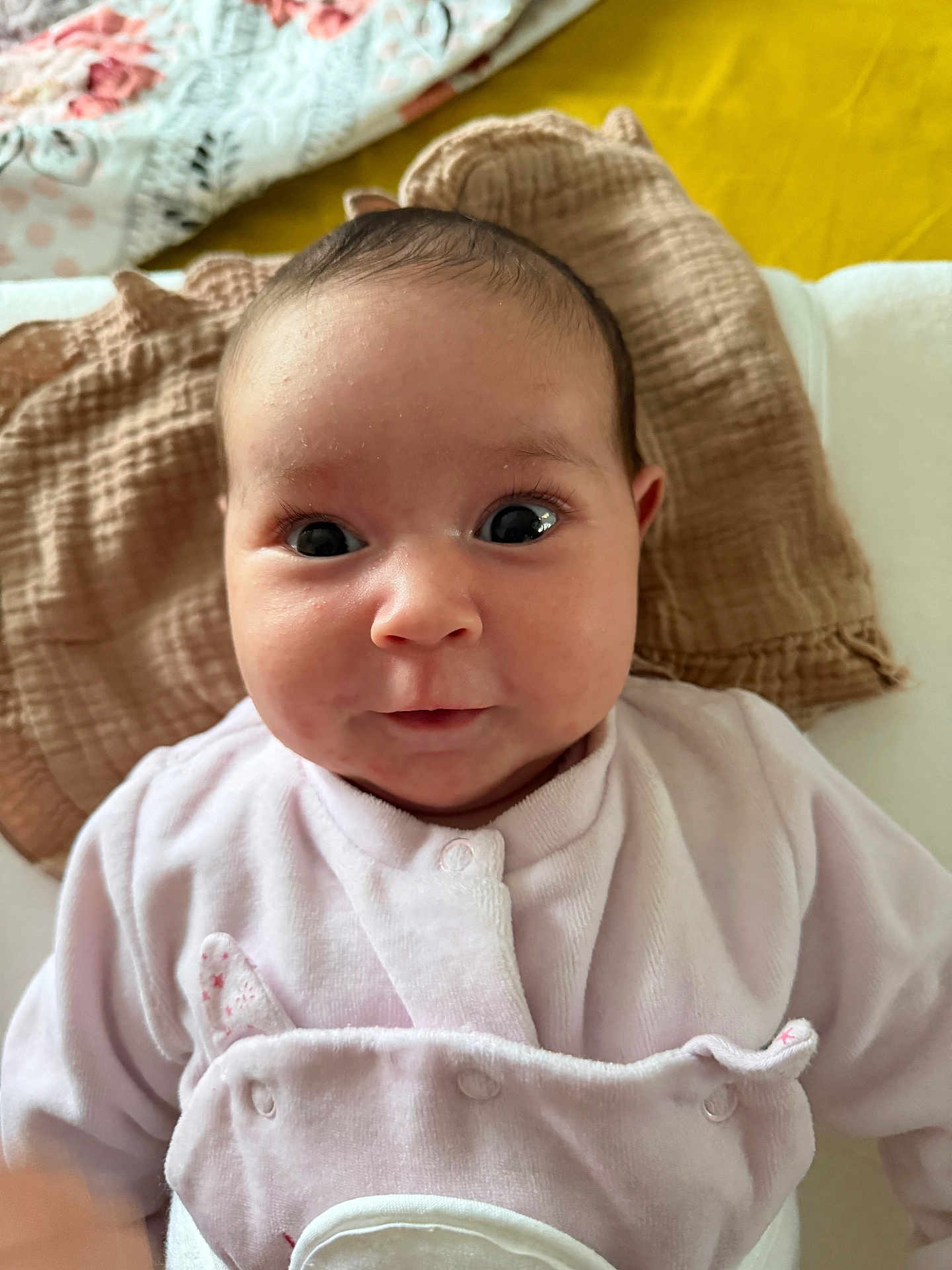 Célia participe au concours pour gagner de l'argent avec cette photo : baby, infant, face, eyes, clothing, blanket, pink, yellow, portrait, cute, child, closeup, newborn, soft, warm, expression, person, indoors, head, smile