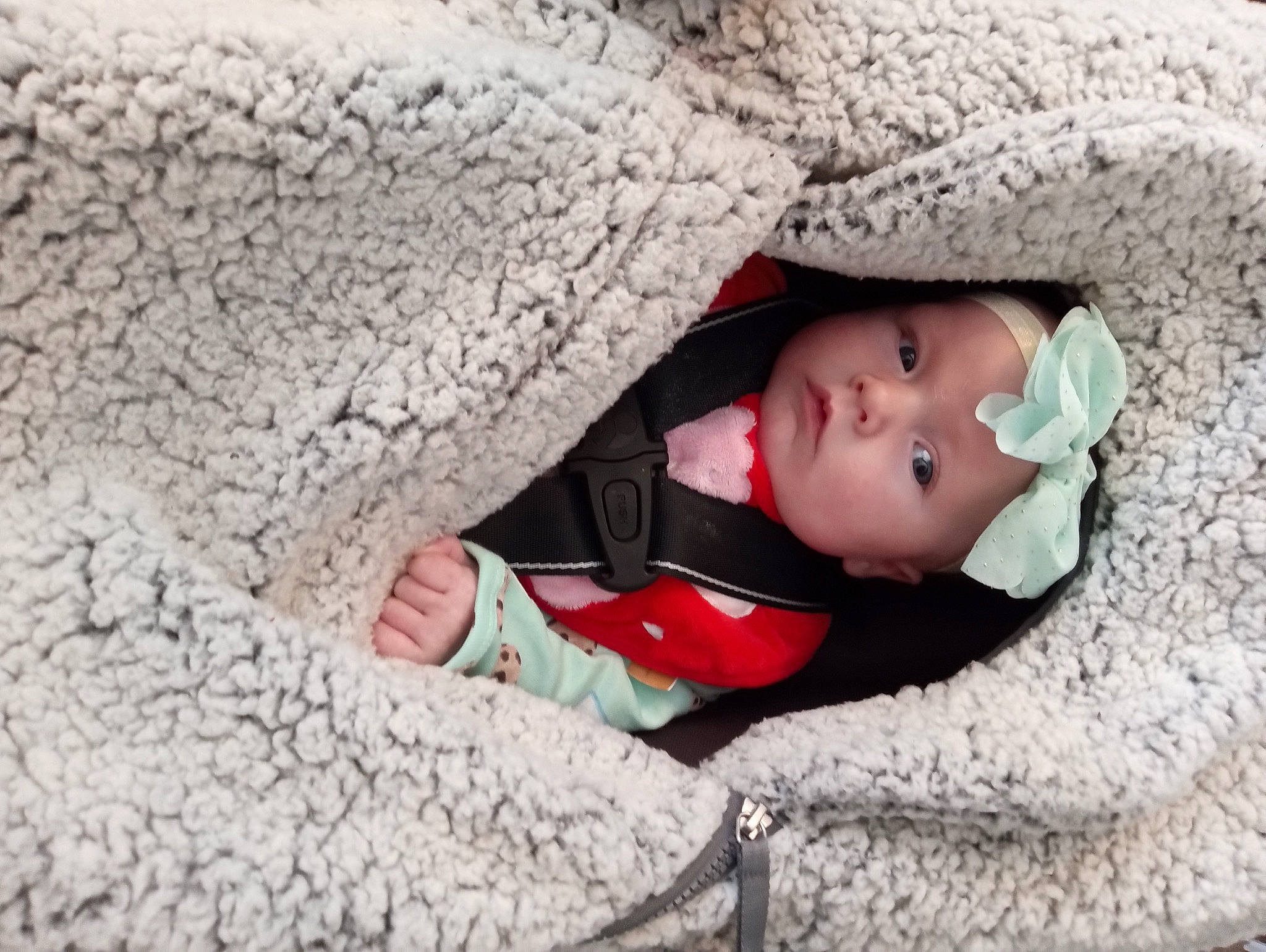 Megan is registered to the contest to win money with this photo: baby, baby_products, baby_toddler_clothing, child, comfort, eye, flooring, grass, grey, head, headgear, headwear, linens, pattern, person, sitting, skin, textile, toddler, tree