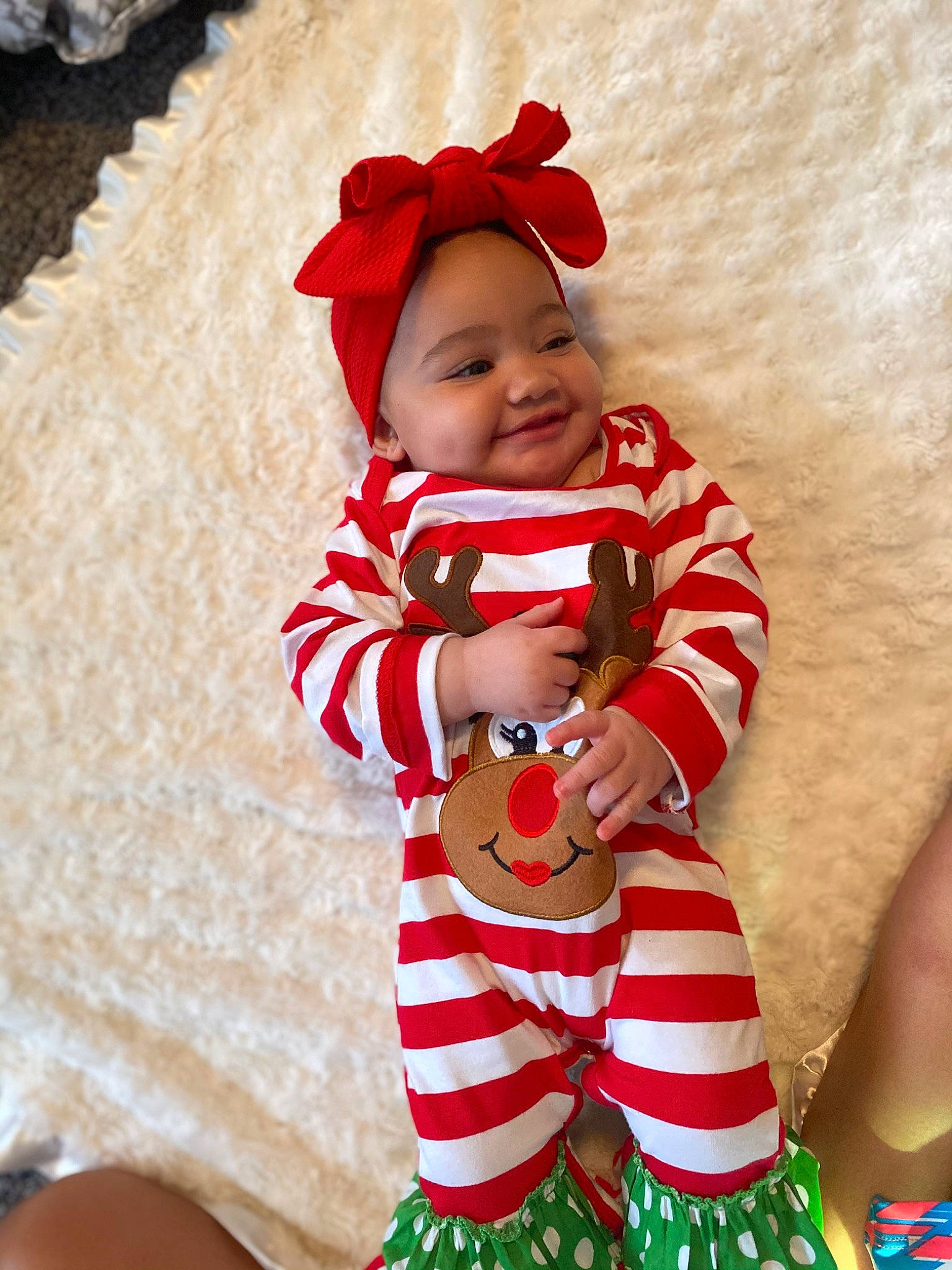 Azara is registered to the contest to win money with this photo: baby, baby_laughing, baby_products, baby_toddler_clothing, bonnet, child, christmas, costume_accessory, costume_hat, headwear, holiday, human, joy, laugh, person, photo_shoot, red, skin, sock, toddler