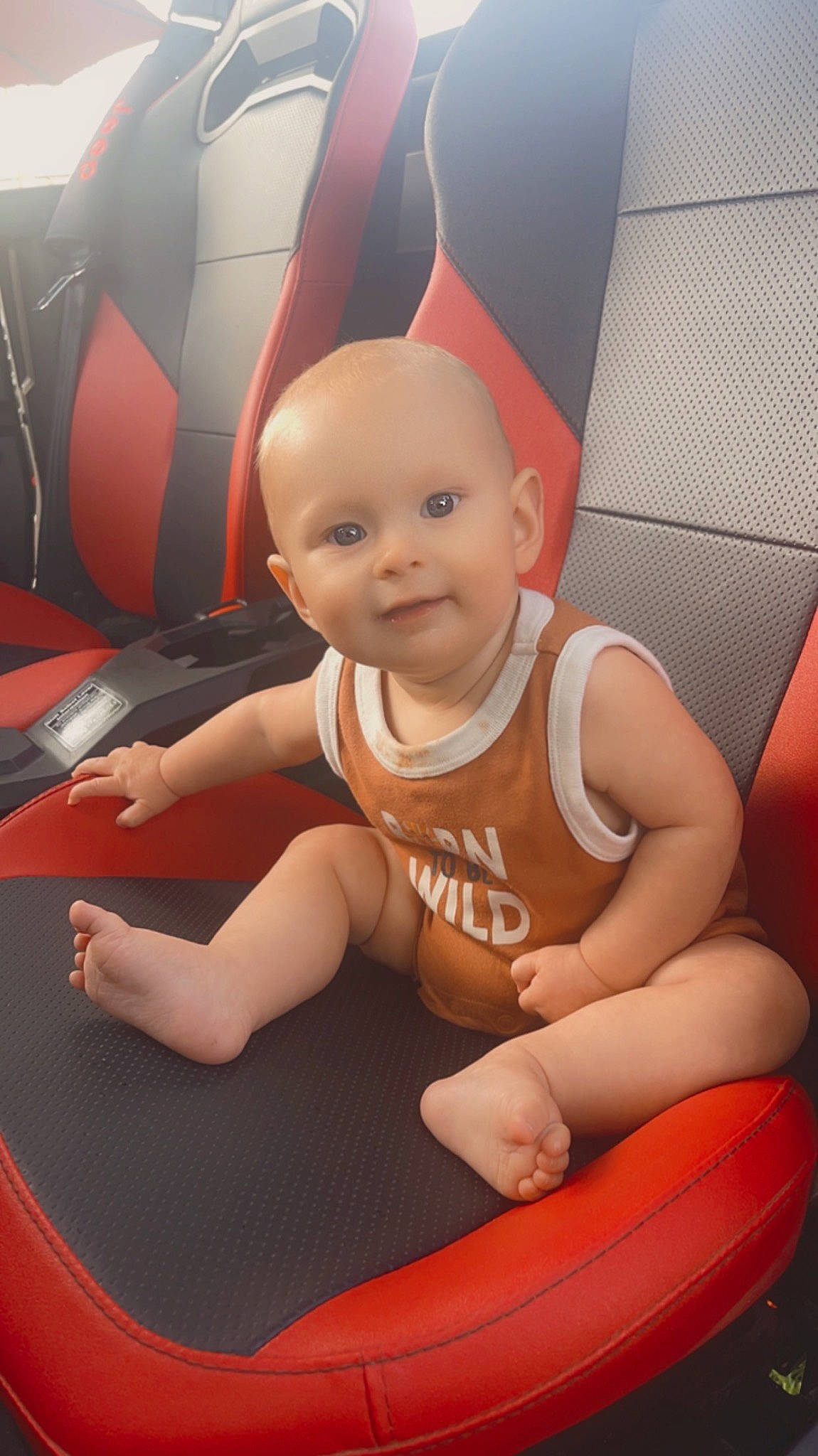 Everest is registered to the contest to win money with this photo: arm, baby, baby_products, baby_toddler_clothing, carmine, child, fictional_character, finger, flooring, fun, happy, human_leg, joy, knee, leg, person, sitting, smile, t_shirt, thigh