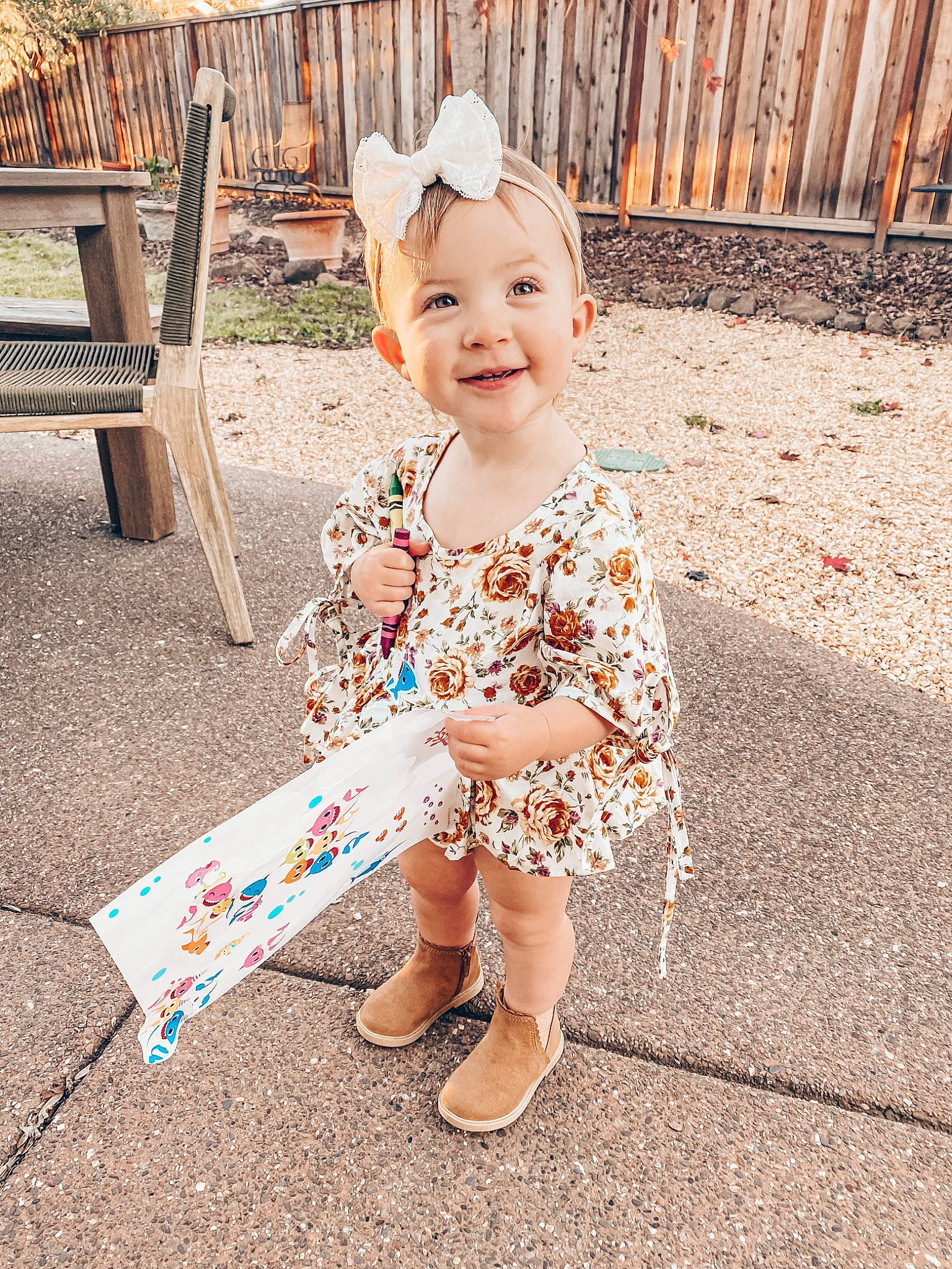 Wrenley is registered to the contest to win money with this photo: baby, baby_toddler_clothing, child, dress, foot, fun, grass, happy, hat, headwear, joy, leisure, pattern, people_in_nature, person, recreation, sandal, sitting, sleeve, smile