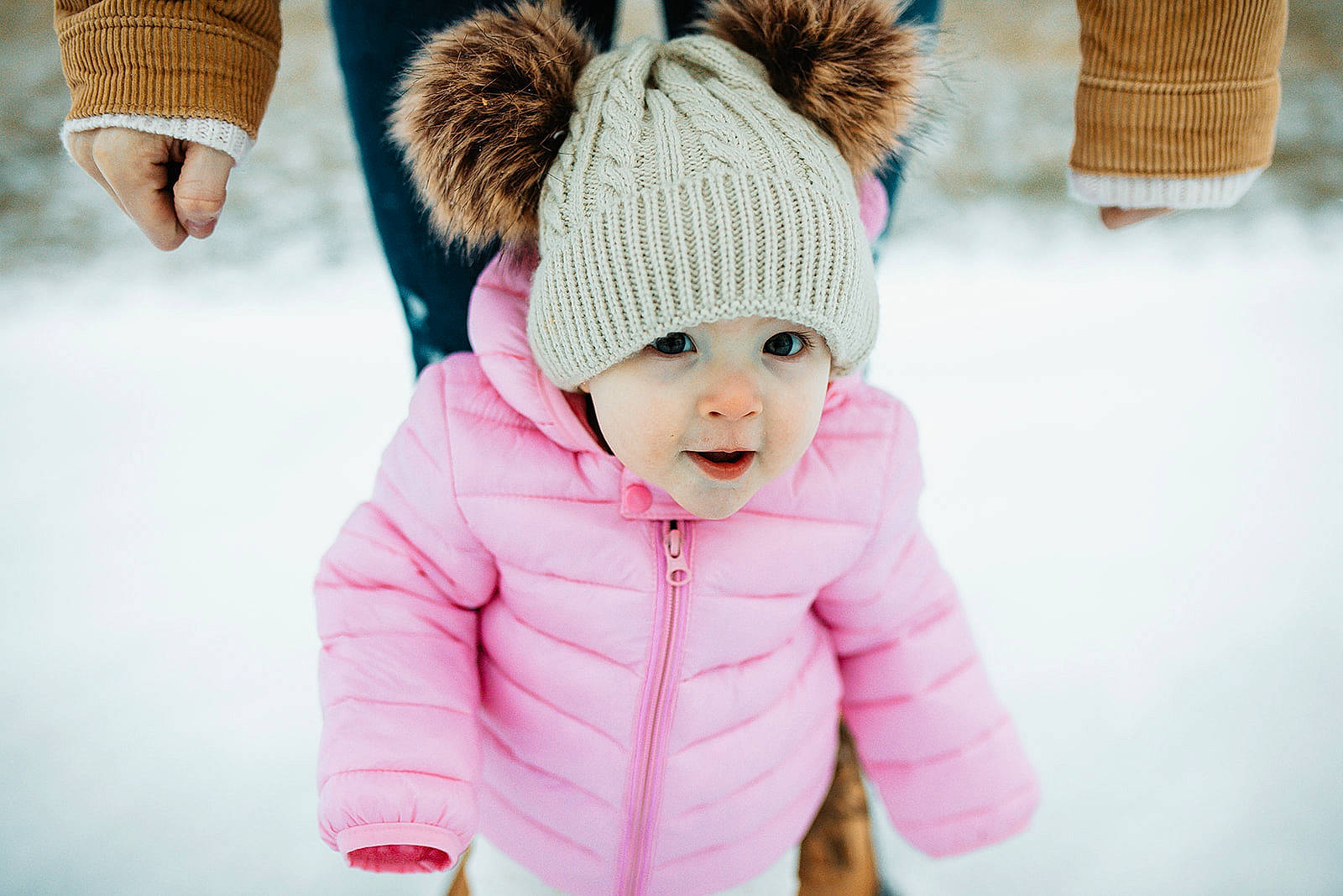 Wrenley is registered to the contest to win money with this photo: cap, freezing, fun, fur, glove, happy, headgear, headwear, jacket, knit_cap, magenta, outerwear, person, sleeve, smile, snow, street_fashion, toddler, tree, winter