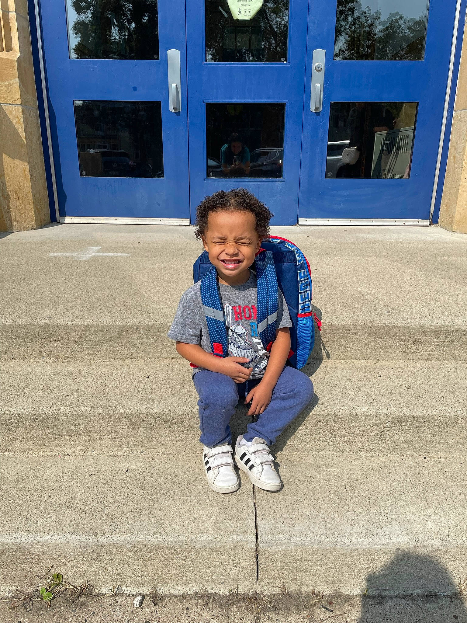 Dvon joined the competition — help win amazing prizes! asphalt, blue, child, concrete, denim, door, electric_blue, fun, human, leisure, person, public_space, road_surface, shadow, sidewalk, sitting, smile, sorrow, standing, toddler