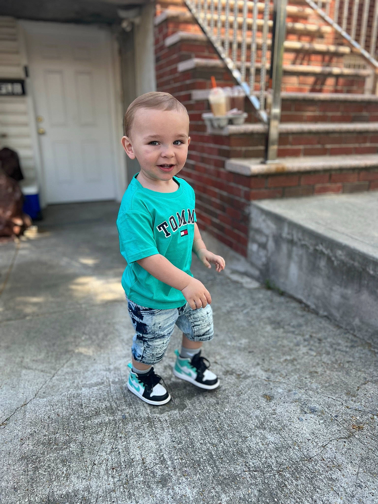 Michael is registered to the contest to win money with this photo: baby, baby_toddler_clothing, child, cool, door, electric_blue, flooring, fun, grass, handrail, happy, joy, leisure, person, play, shorts, stairs, standing, t_shirt, toddler