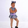 Alura joined the competition — help win amazing prizes! black_shoes, bow, child, confident, cute, dance_costume, fashion, girl, happy, performance, portrait, posing, purple, smile, sparkly, standing, studio, tights, white_background, young