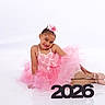 2026, ballet, ballet_shoes, child, cute, dance, dress, flower, girl, happy, headpiece, legwear, numbers, pink, portrait, pose, smile, studio, tutu, white_background