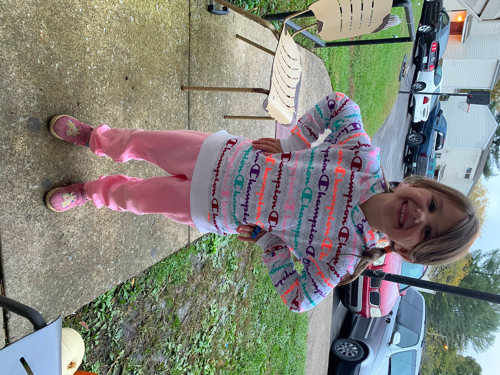 Kennedy is registered to the contest to win money with this photo: car, family_car, fun, grass, human_leg, joy, leisure, magenta, pattern, person, photograph, pink, recreation, sky, smile, snapshot, street_fashion, thigh, tire, toddler