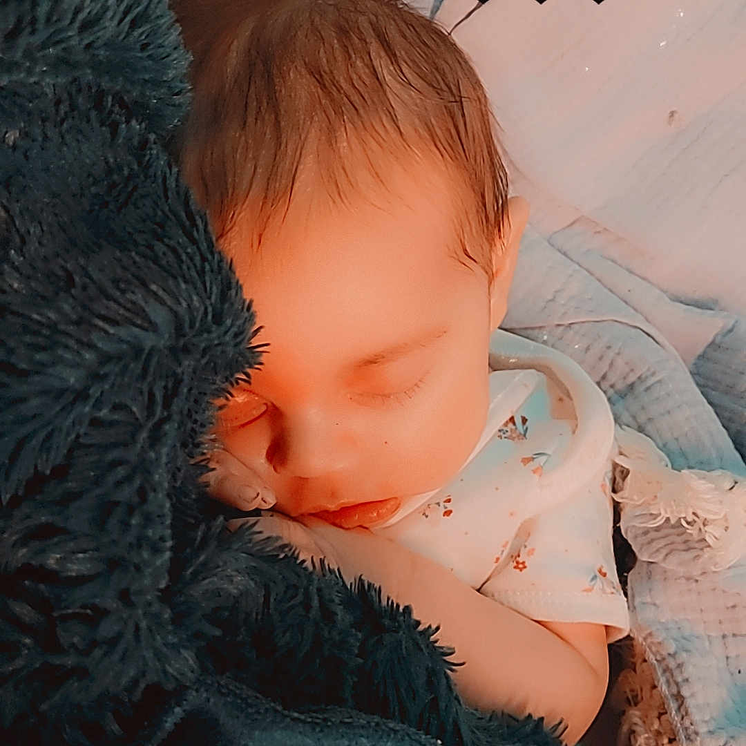 Rylie joined the competition — help win amazing prizes! baby, bed, blanket, bodypart, clothing, face, finger, furniture, hand, happy, head, knitwear, newborn, person, photography, portrait, quilt, sleeping, smile, sweater