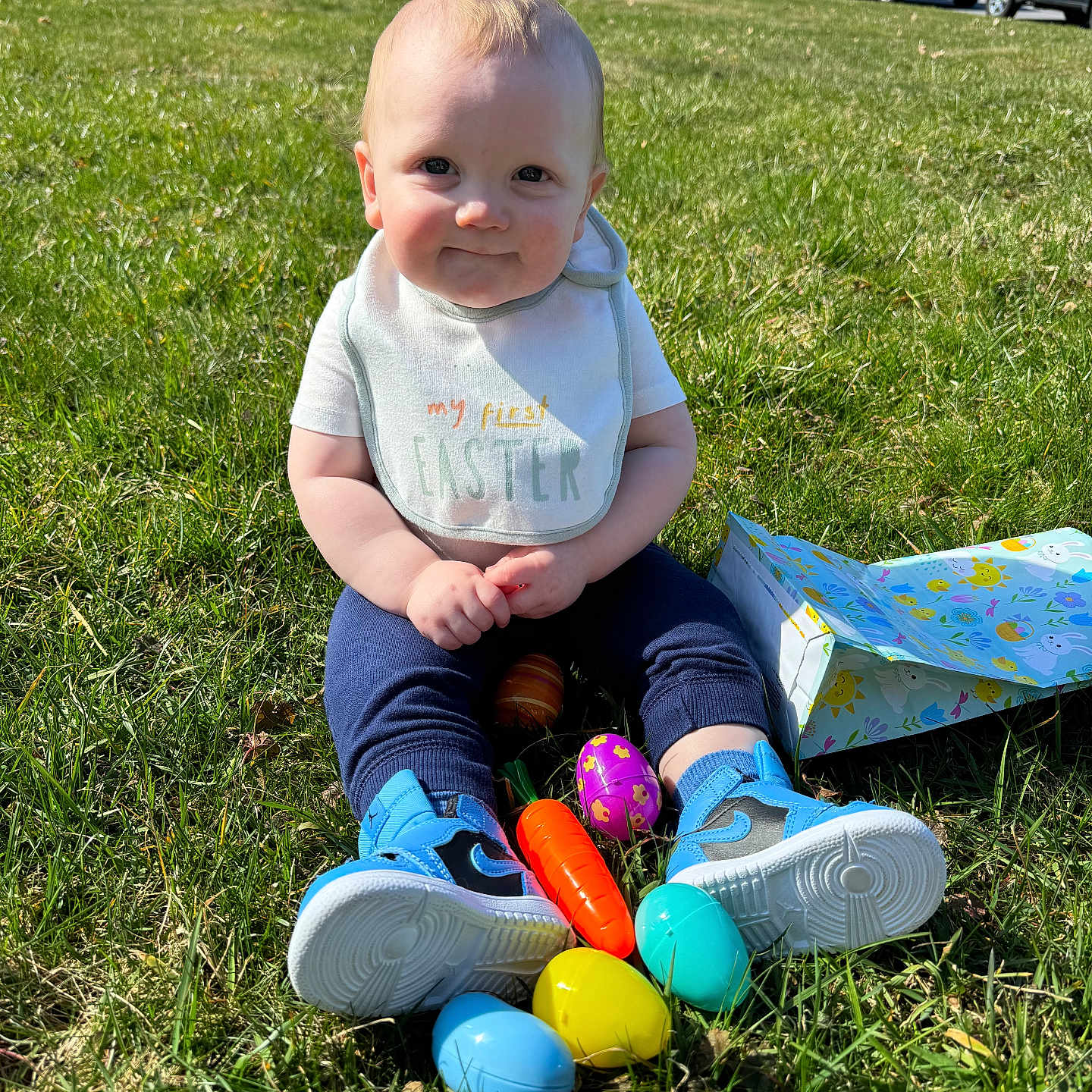 Myles is registered to the contest to win money with this photo: baby, car, clothing, face, field, footwear, grass, grassland, head, lawn, nature, outdoors, park, person, photography, plant, portrait, shoe, transportation, vehicle