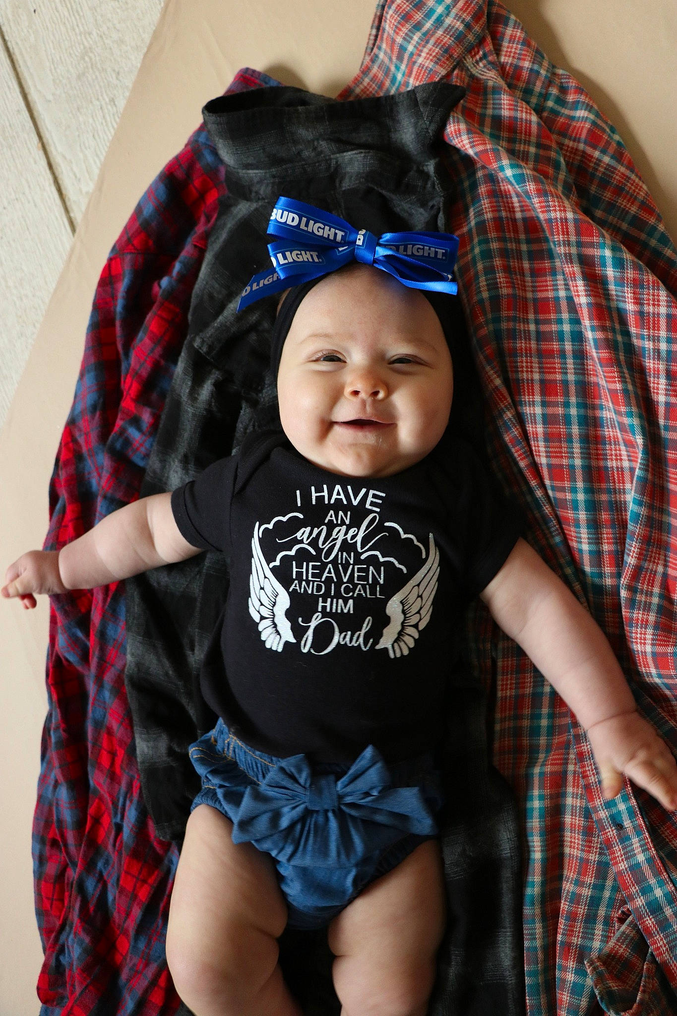 Madalynn is registered to the contest to win money with this photo: baby, baby_toddler_clothing, blue, cap, child, comfort, electric_blue, head, headwear, joy, linens, outerwear, pattern, person, personal_protective_equipment, plaid, sleeve, smile, t_shirt, tartan