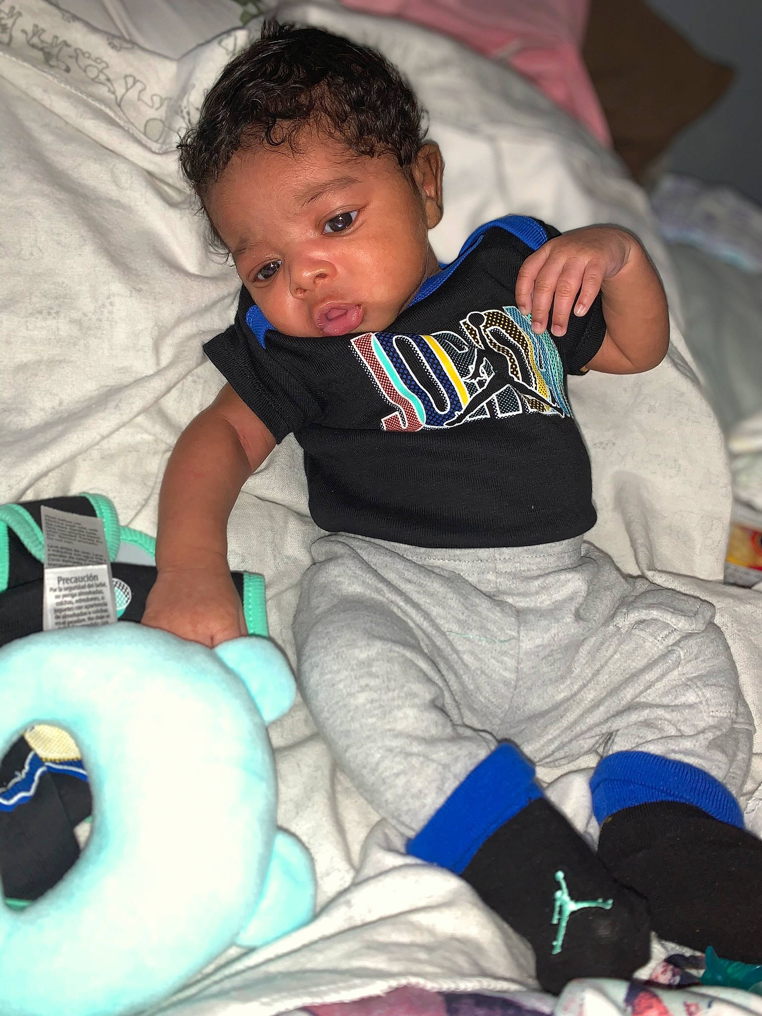 Deshawn is registered to the contest to win money with this photo: baby, baby_products, baby_toddler_clothing, black, child, comfort, event, fun, green, happy, human_leg, lap, mammal, person, product, room, sitting, sock, t_shirt, thigh