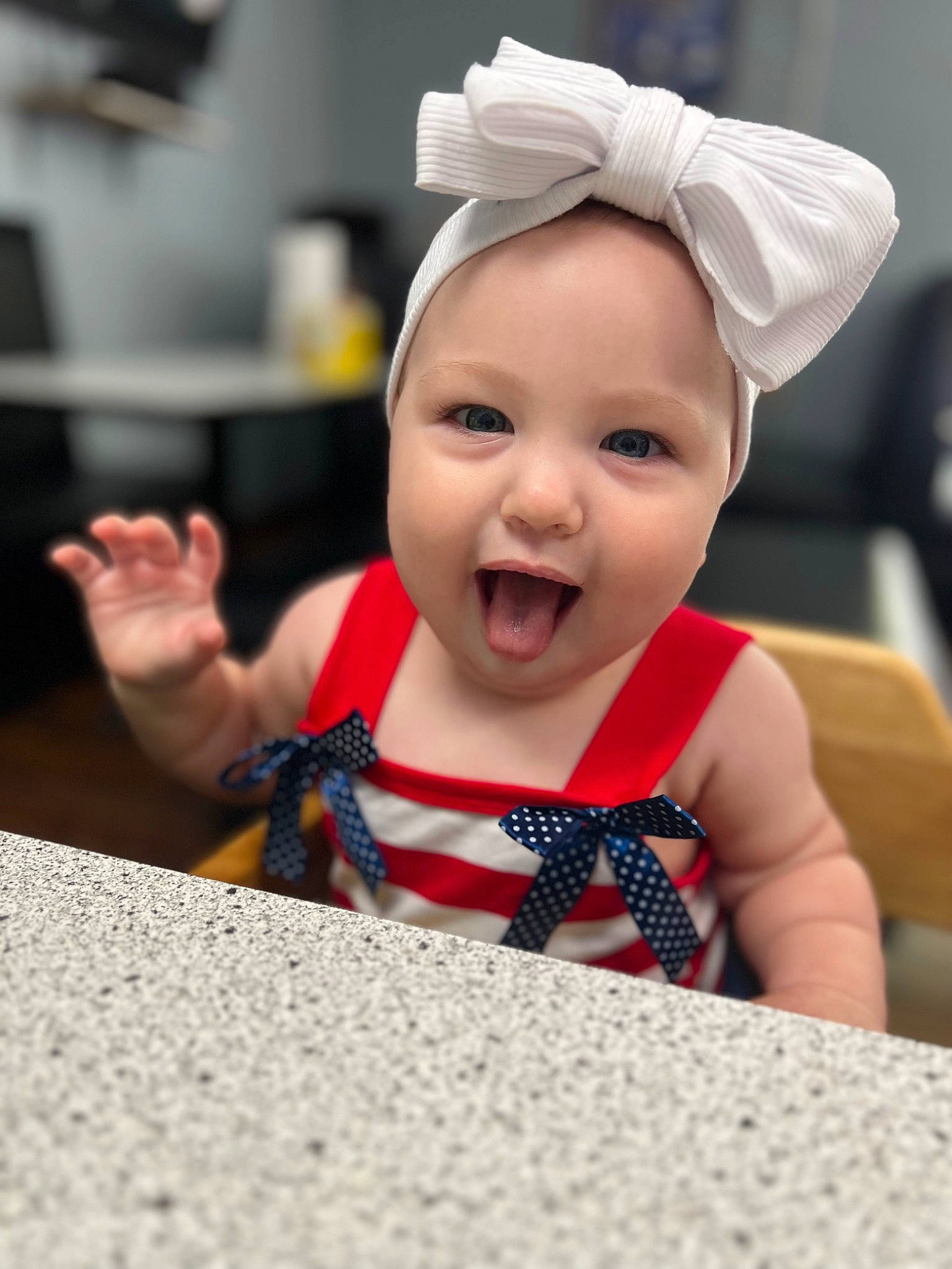 Gracie joined the competition — help win amazing prizes! baby, baby_toddler_clothing, cap, carmine, child, event, fashion_accessory, finger, fun, gesture, happy, headgear, headwear, human, mouth, person, room, sitting, skin, smile