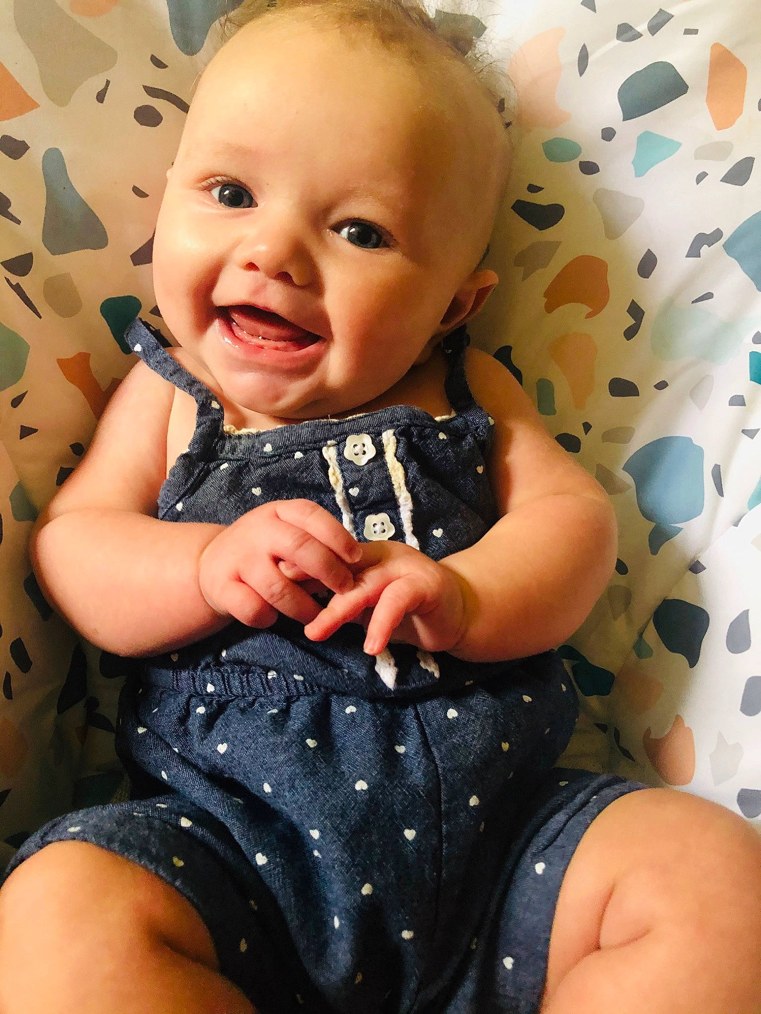 Emeri is registered to the contest to win money with this photo: baby, baby_products, baby_toddler_clothing, cheek, child, finger, hand, nail, pattern, person, product, sitting, skin, toddler