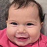 baby, child, infant, smiling, happy, portrait, close_up, face, eyes, bow, hair, pink_clothing, sweater, indoors, candid, looking_at_camera, cheeks, mouth, cute, photography