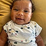 Izlyn joined the competition — help win amazing prizes! baby, child, closeup, comfort, curly_hair, cushion, cute, face, happy, indoor, infant, onesie, patterned_clothing, person, portrait, skin, sleepy_bear_pattern, smiling, yellow, young
