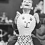 child, toy, llama, bandana, smile, happy, indoor, play, pattern, clothing, face, hands, laugh, kid, background_blur, monochrome, portrait, fun, cute, joy