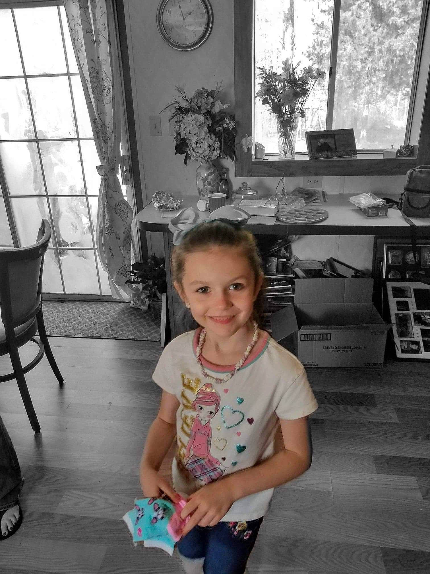 Breelyn is registered to the contest to win money with this photo: black, black_and_white, clock, eye, floor, flooring, hairstyle, happy, houseplant, joy, monochrome, monochrome_photography, person, photograph, plant, smile, snapshot, standing, style, toddler