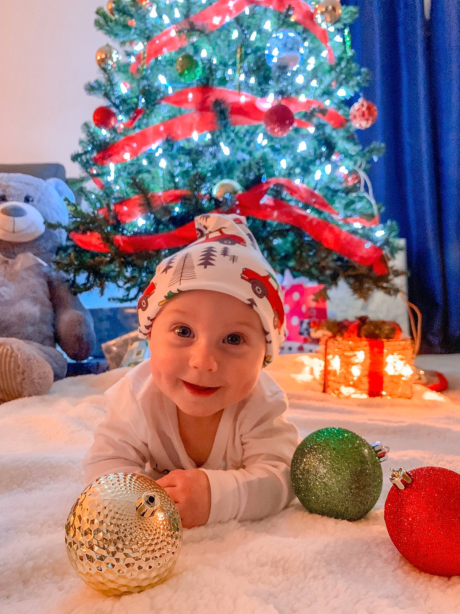 Cole is registered to the contest to win money with this photo: child, christmas, christmas_decoration, christmas_eve, christmas_ornament, christmas_tree, conifer, event, fir, headwear, holiday, holiday_ornament, interior_design, ornament, person, pine_family, plant, smile, toddler, tree