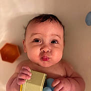 Joanna is registered to the contest to win money with this photo: baby, bath, child, chubby_cheeks, closeup, cute, expression, face, hands, holding, indoor, infant, playful, portrait, rubber_duck, skin, soft_light, toy, water, young