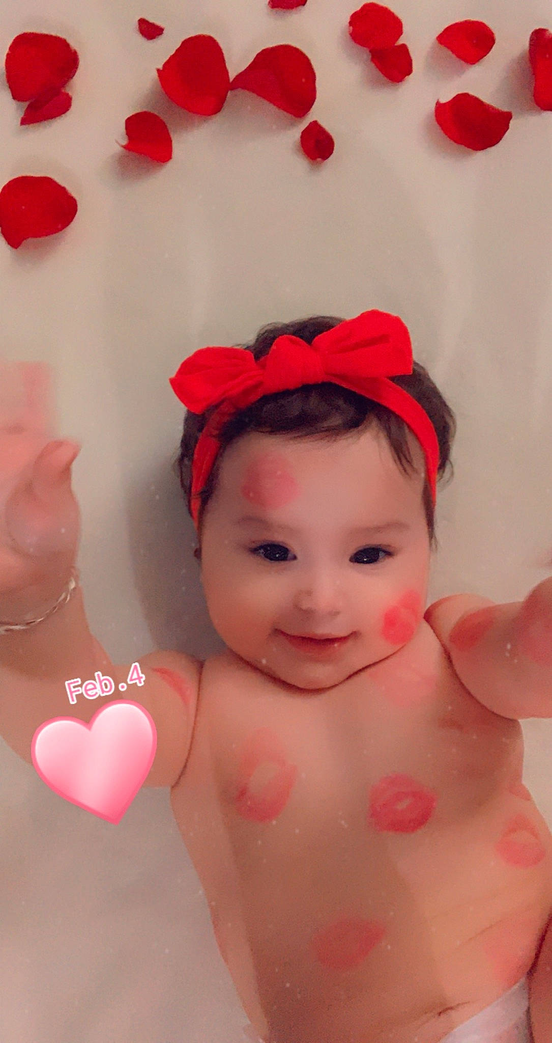 Jaylani is registered to the contest to win money with this photo: arm, baby, bathing, cheek, eye, eyelash, finger, hand, happy, headgear, human_body, joy, lip, mouth, muscle, neck, organ, person, pink, red