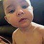 Octavia is registered to the contest to win money with this photo: baby, child, face, skin, eyes, nose, mouth, ear, shoulder, arm, couch, indoor, natural_light, window, curious, chubby_cheeks, portrait, young_child, sitting, shirtless