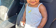 Jayciona is registered to the contest to win money with this photo: car_seat, child, curly_hair, cute, grey_tank_top, happy, indoor, jewelry, leather_seat, necklace, person, pink_hair_clips, pink_ruffles, portrait, smiling, sunlight, toddler, vehicle_interior, white_pants, white_shoes