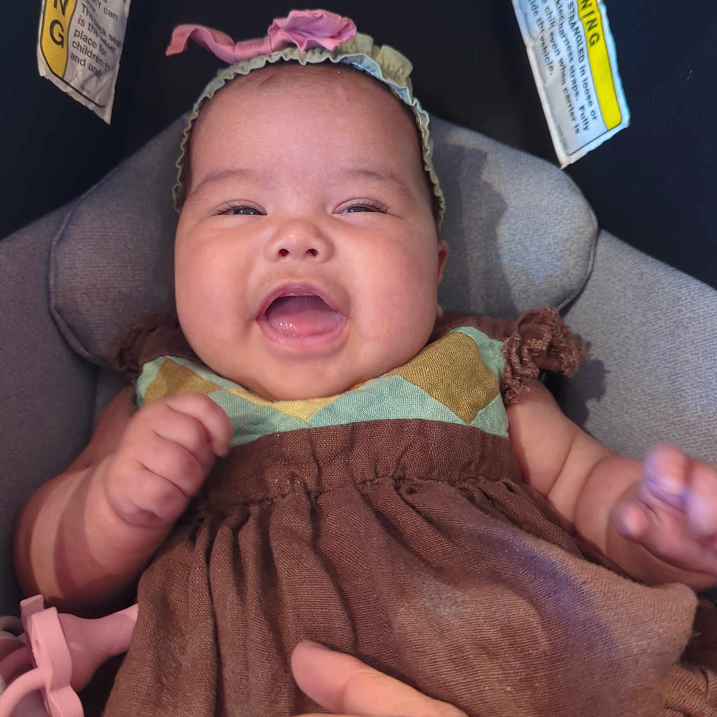 Shay is registered to the contest to win money with this photo: baby, bodypart, bonnet, cap, clothing, couch, face, finger, frown, furniture, hand, hat, head, newborn, person, photography, portrait, sad, toe, wrist