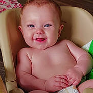 Sunnie joined the competition — help win amazing prizes! baby, smiling, diaper, plastic_seat, happy, child, infant, floor, toy, blanket, wooden_floor, indoor, skin, hands, feet, face, person, cute, joyful, relaxed