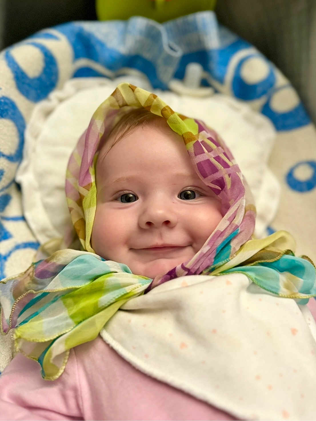 Alexa is registered to the contest to win money with this photo: baby, child, face, smile, scarf, colorful, portrait, closeup, infant, pink_clothing, blanket, soft, cute, happy, indoors, headwear, wrapped, cheeks, eyes, person