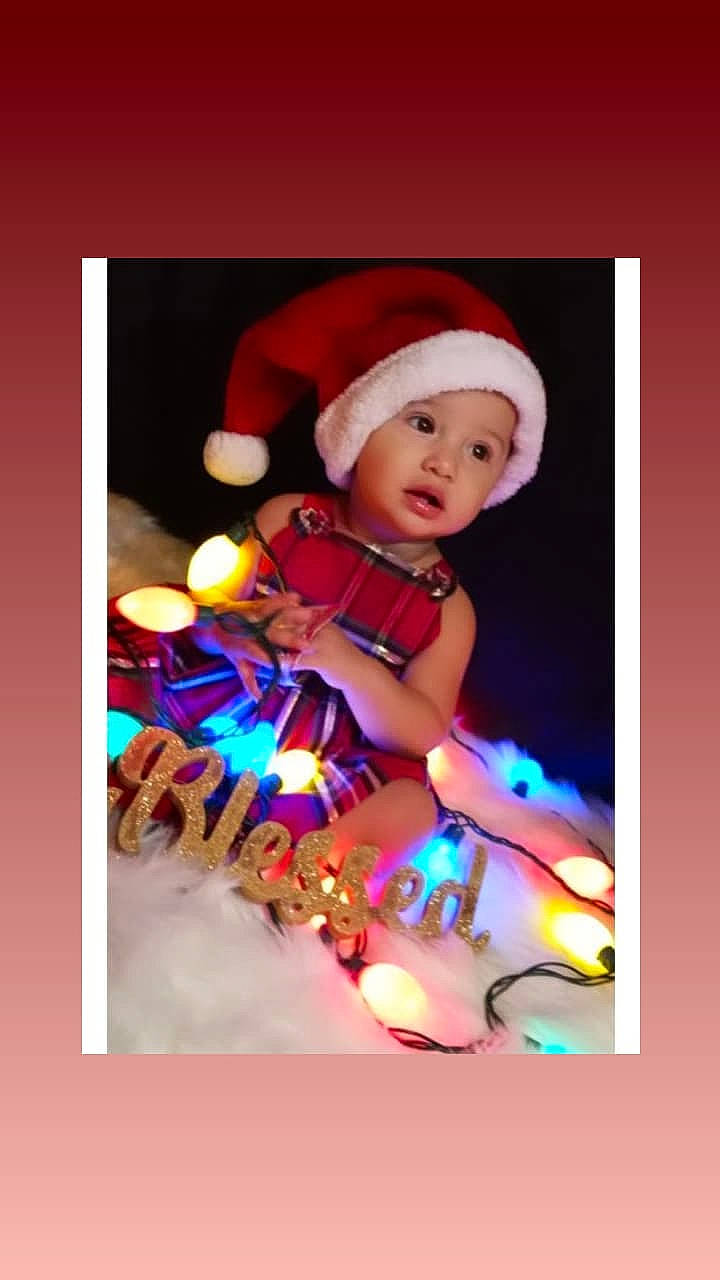 Aleya is registered to the contest to win money with this photo: baby, cap, carmine, christmas, christmas_decoration, christmas_eve, costume_hat, electric_blue, event, fashion_accessory, fictional_character, font, fun, happy, hat, headwear, holiday, human_body, magenta, person