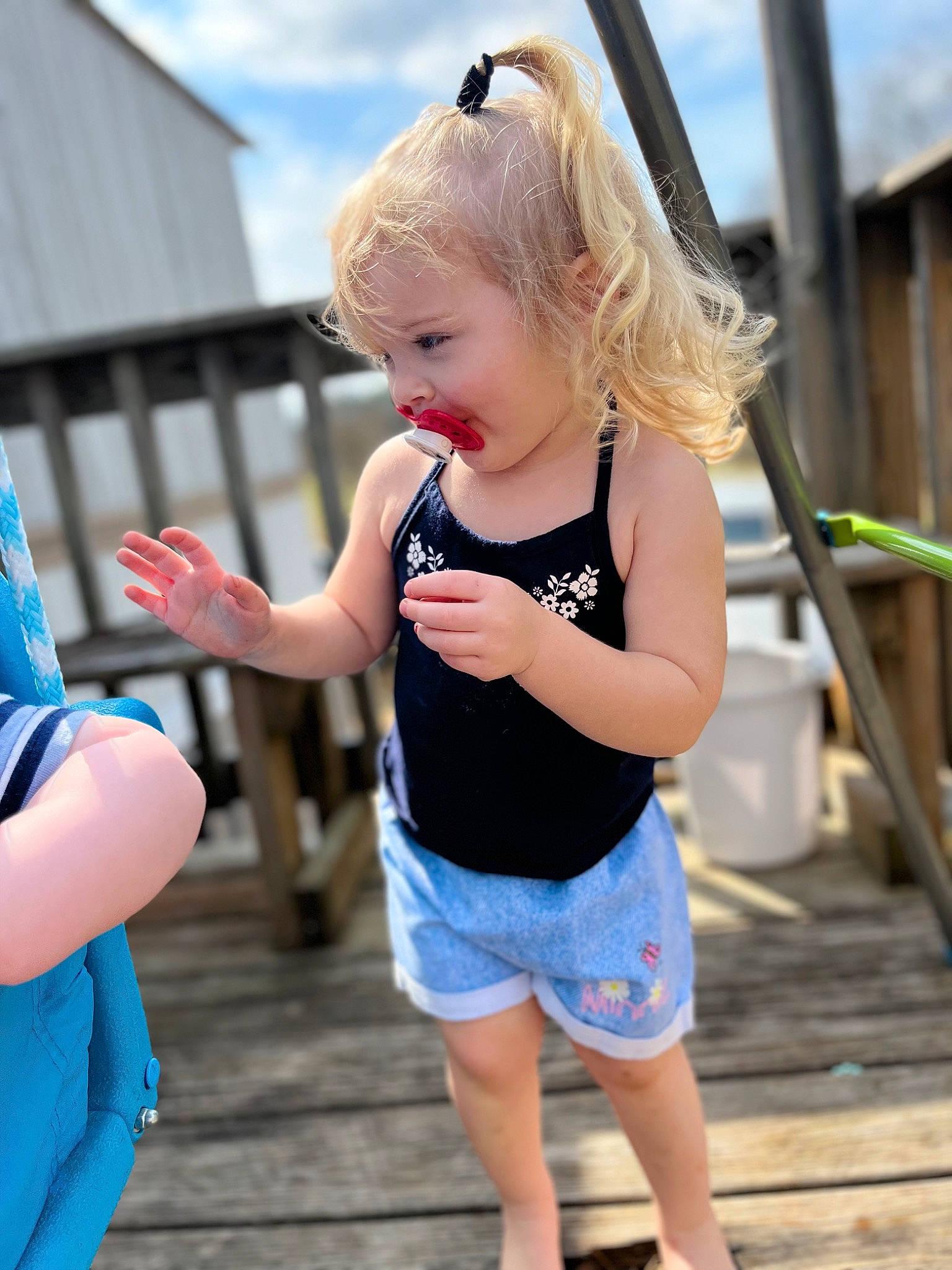 Madalynn joined the competition — help win amazing prizes! blue, child, daytime, fun, gesture, hand, happy, human, joint, leisure, mammal, person, public_space, shorts, shoulder, skin, sky, standing, street_fashion, toddler