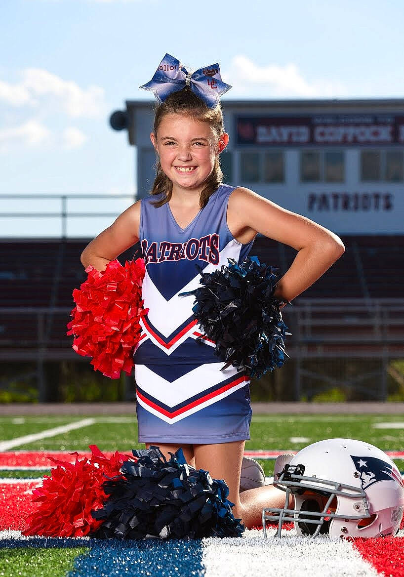 Mallory is registered to the contest to win money with this photo: american_football, cheering, cheerleading, cheerleading_uniform, competition_event, gridiron_football, joy, person, pom_pom, sport_venue, sports, sports_uniform, team_sport, uniform