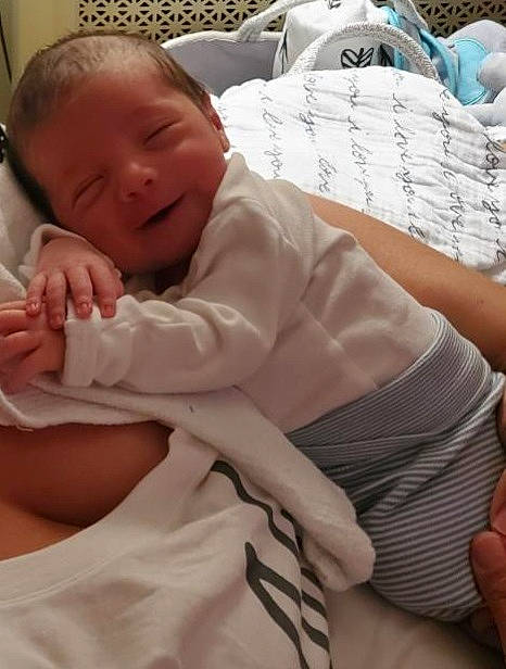 Christopher John is registered to the contest to win money with this photo: abdomen, baby, baby_sleeping, baby_toddler_clothing, cheek, child, comfort, elbow, finger, health_care, linens, nail, pattern, person, sitting, skin, sleeve, smile, thumb, toddler