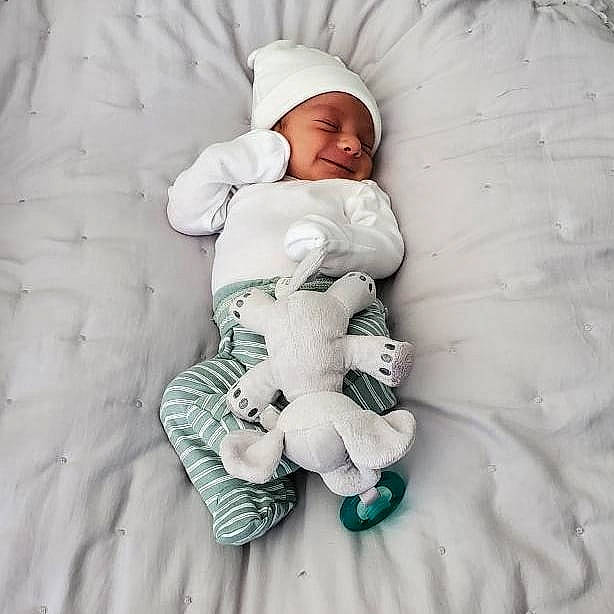 Christopher John is registered to the contest to win money with this photo: baby, baby_products, baby_sleeping, baby_toddler_clothing, child, comfort, face, freezing, gesture, hand, happy, joy, linens, person, skin, sleeve, smile, textile, thumb, toddler