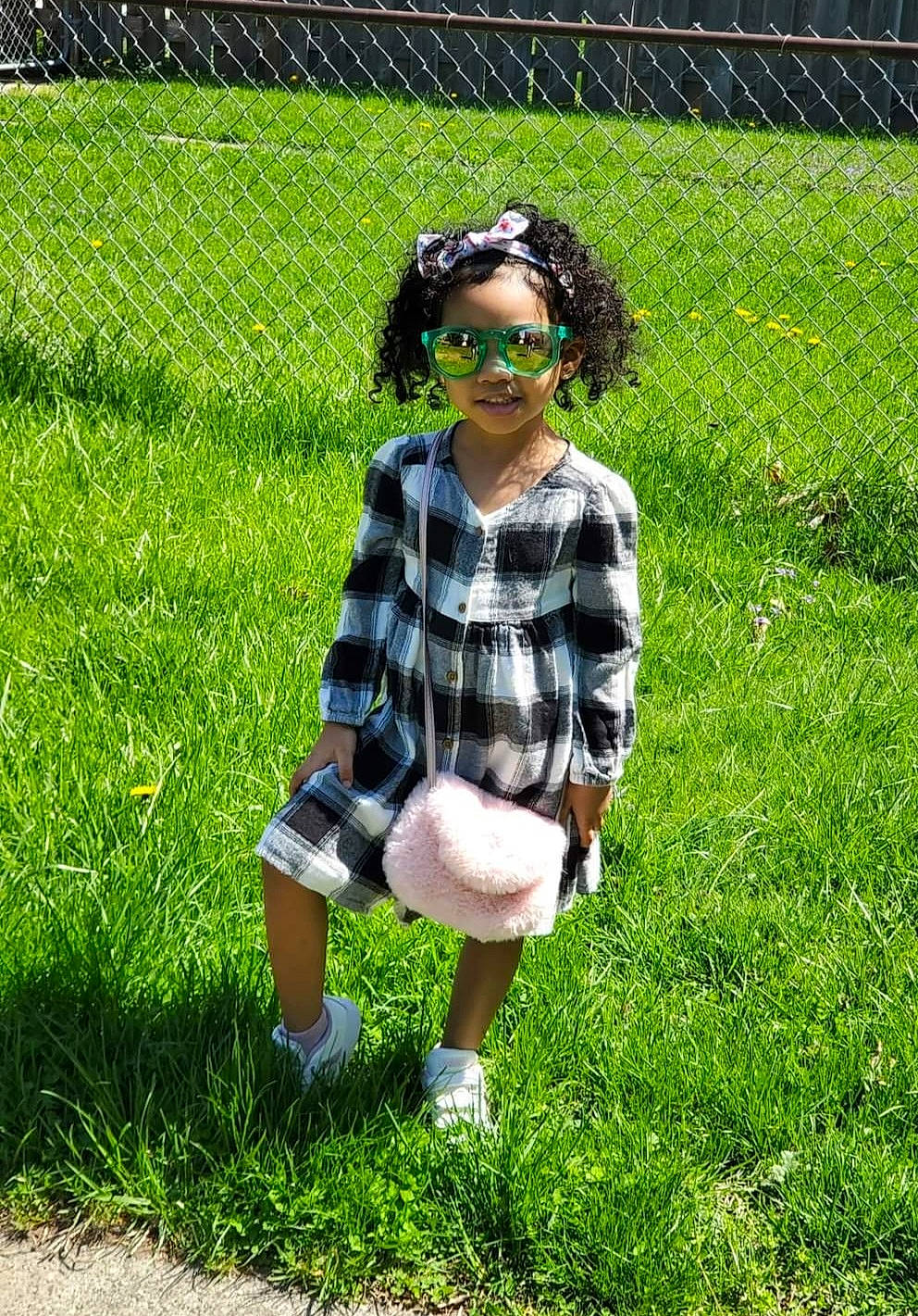 Brianna joined the competition — help win amazing prizes! child, doll, eyewear, fence, fun, garden, grass, grass_family, grassland, groundcover, lawn, leisure, meadow, pattern, people_in_nature, person, plaid, shadow, sunglasses, toy