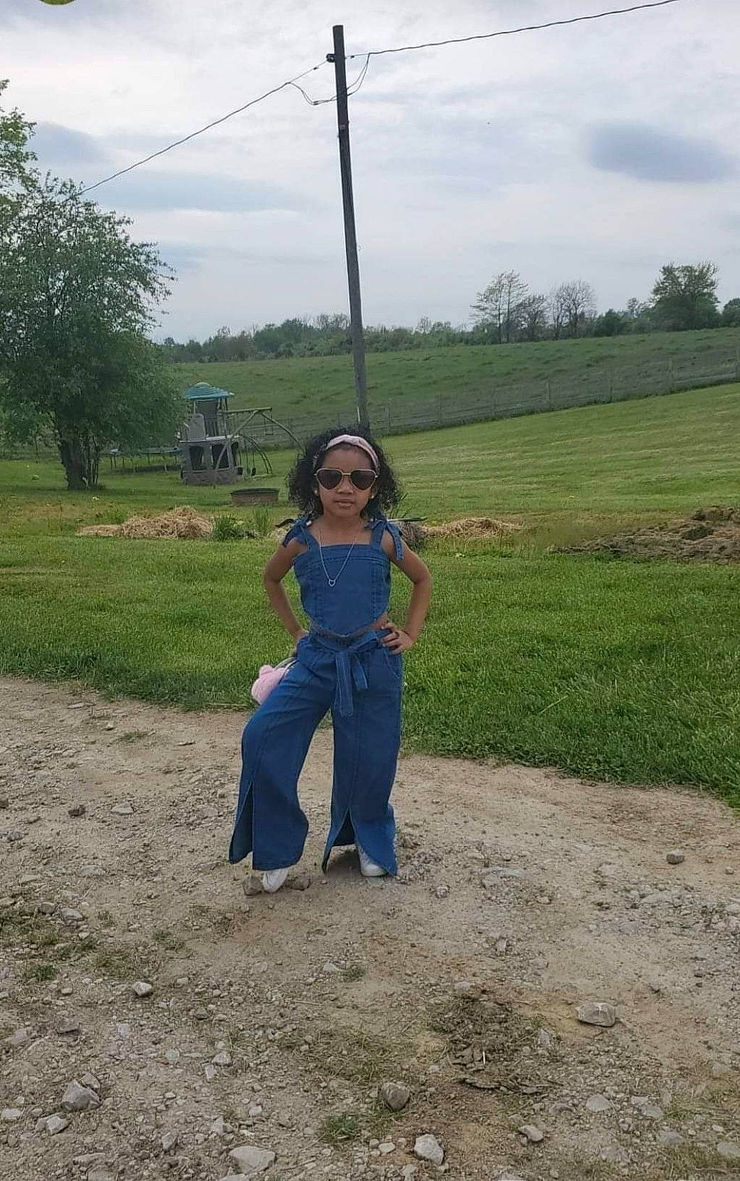 Brianna is registered to the contest to win money with this photo: cloud, electric_blue, field, fun, grass, grassland, landscape, leisure, overhead_power_line, pasture, people_in_nature, person, plain, plant, pole, prairie, recreation, sky, soil, tree
