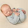 Westin is registered to the contest to win money with this photo: newborn, baby, sleeping, infant, knitted_outfit, soft_texture, cozy, peaceful, curled_up, cute, portrait, closeup, skin, hands, feet, neutral_background, child, resting, small, adorable